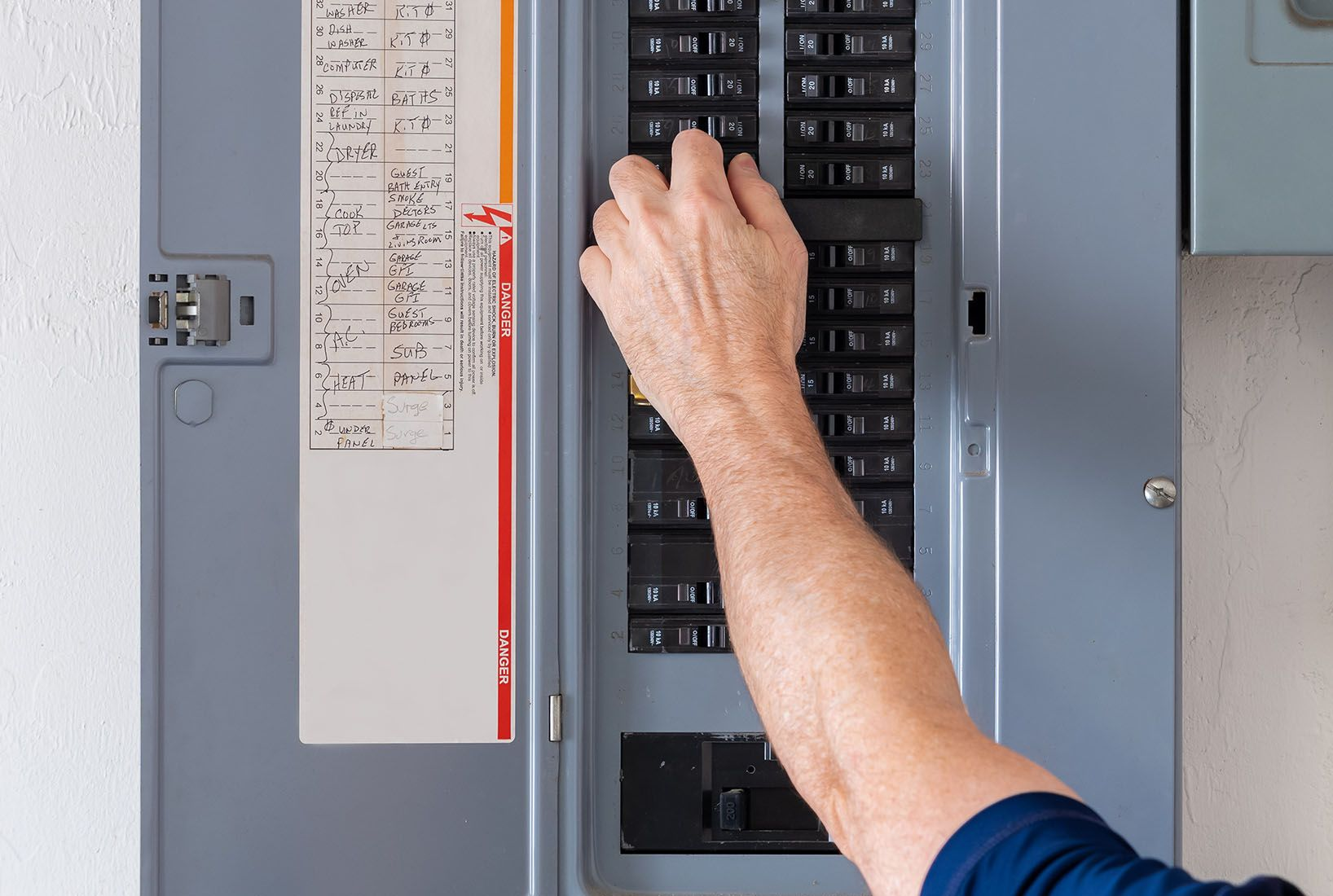 Electrician working on breaker panel