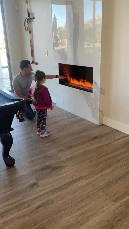 Electric fireplace wired into a marble feature wall - Orozco Electric Gilbert